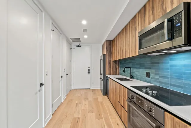 a kitchen with stainless steel appliances granite countertop a stove and a microwave