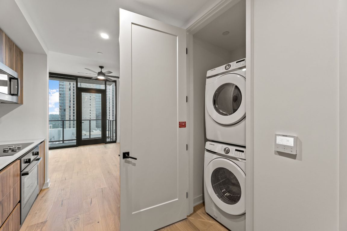 84 East Avenue, Unit 2108 Austin, TX 78701 - Photo 6 of 11 a view of a hallway with washer and dryer