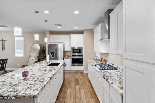 a kitchen with refrigerator and chairs