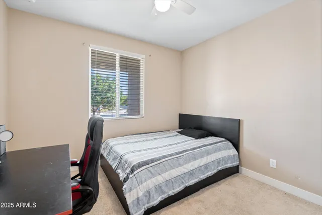 a large kitchen with kitchen island a large counter top stainless steel appliances and cabinets