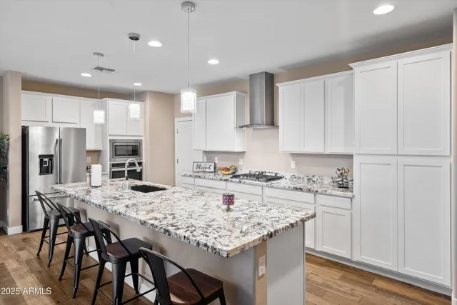 a living room with kitchen island furniture and a wooden floor