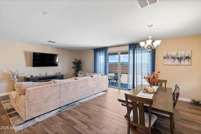 a kitchen with kitchen island granite countertop a table chairs sink and cabinets