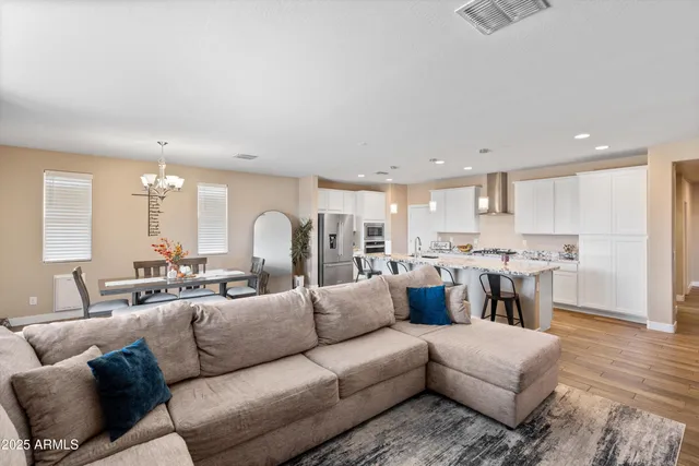 a living room with furniture a flat screen tv and a large window