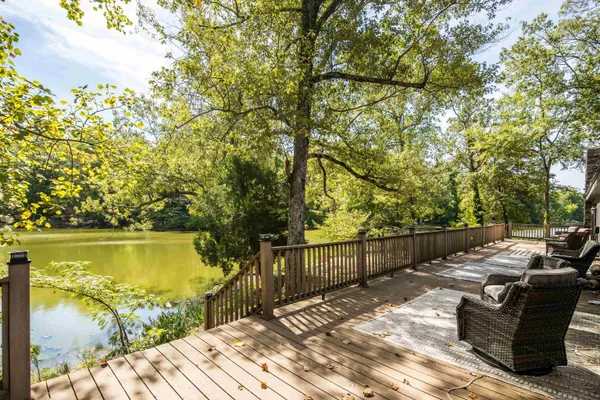 a view of a lake with couches and wooden floor
