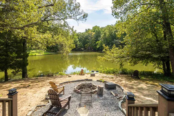 a view of a lake with lawn chairs