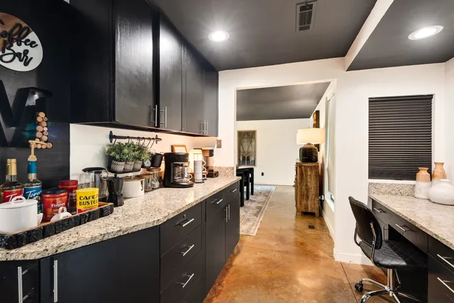 a kitchen with kitchen island granite countertop lots of counter top space and furniture