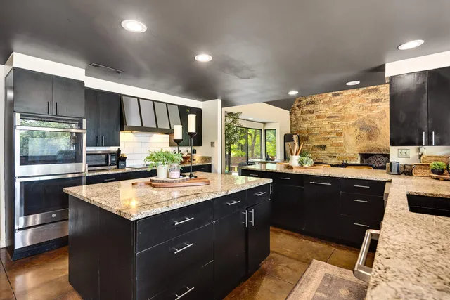 a view of kitchen island a sink and living room