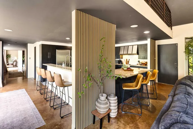 a dining room with furniture and wooden floor