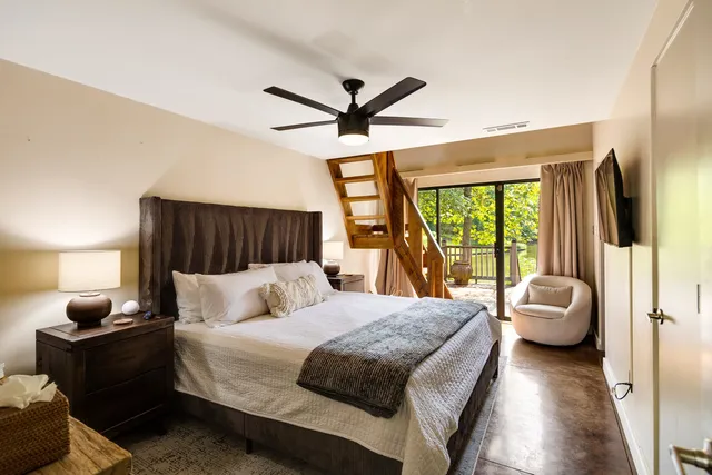 a bedroom with a bed and ceiling fan