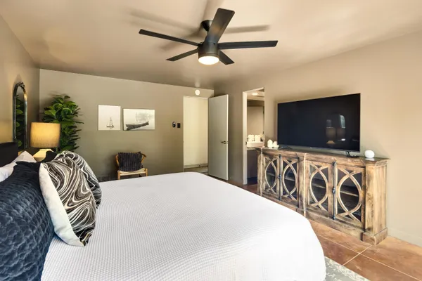 a bedroom with a large bed and a large window
