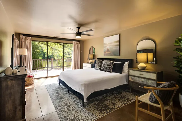 a bedroom with a large bed and a large window