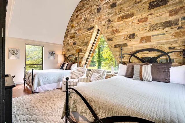 a bedroom with a bed and a table with window