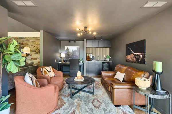 a living room with furniture and a chandelier