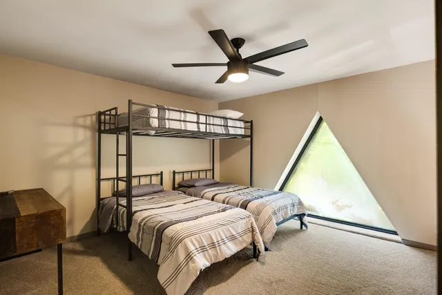 a bedroom with two beds and a window