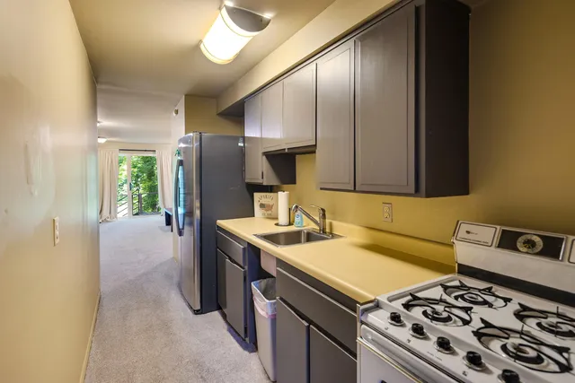 a kitchen with a stove and a refrigerator
