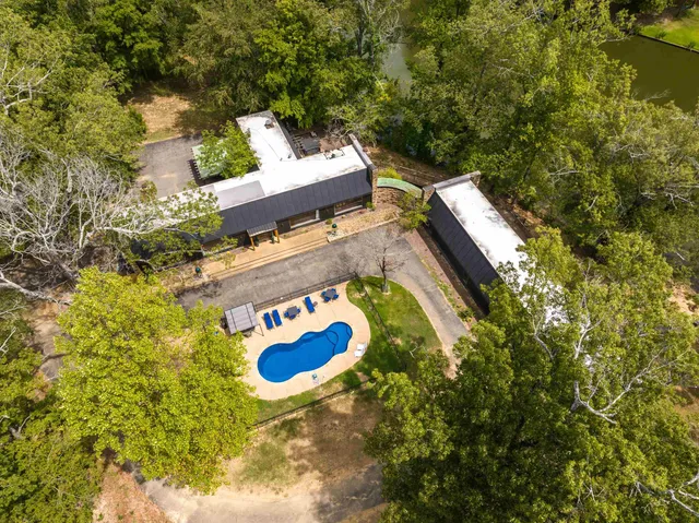 a view of a swimming pool with a yard