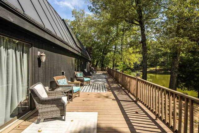 a view of a lake with couches and wooden floor