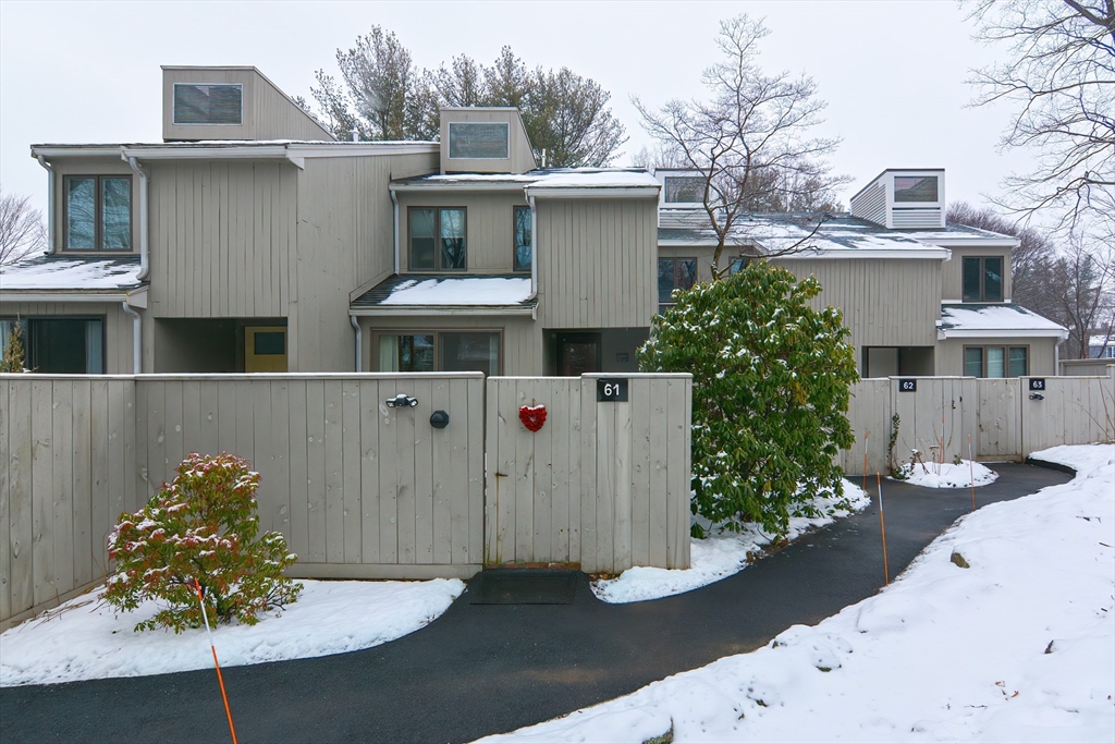 61 Mill Pond, Unit 61 North Andover, MA 01845 - Photo 1 of 31 a view of a white house with large windows and a yard with plants