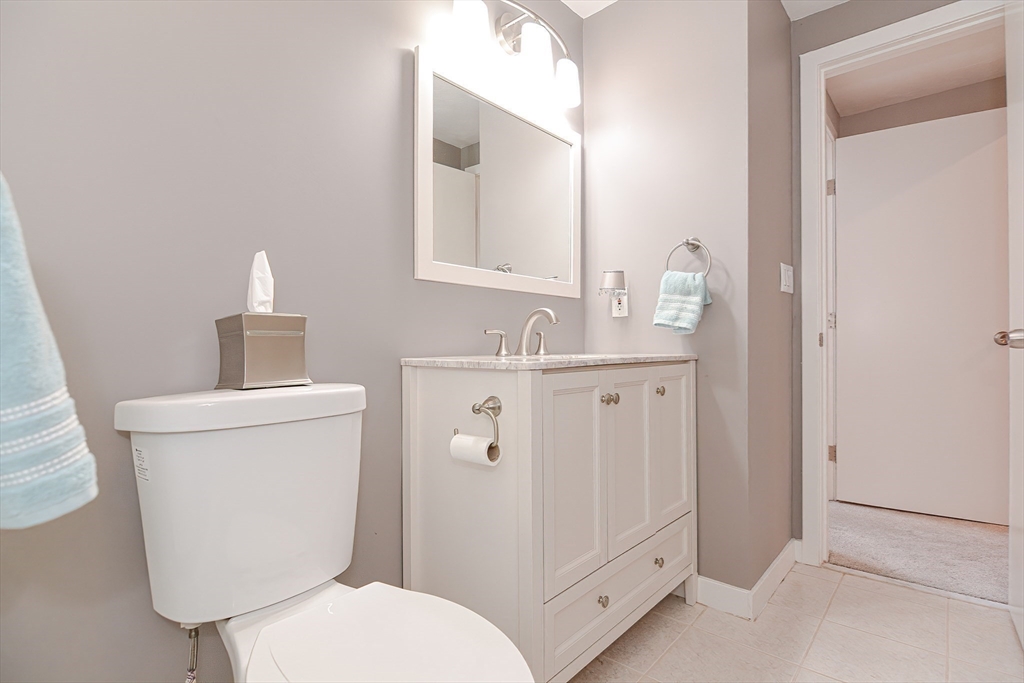 61 Mill Pond, Unit 61 North Andover, MA 01845 - Photo 12 of 31 a bathroom with a toilet sink vanity and mirror