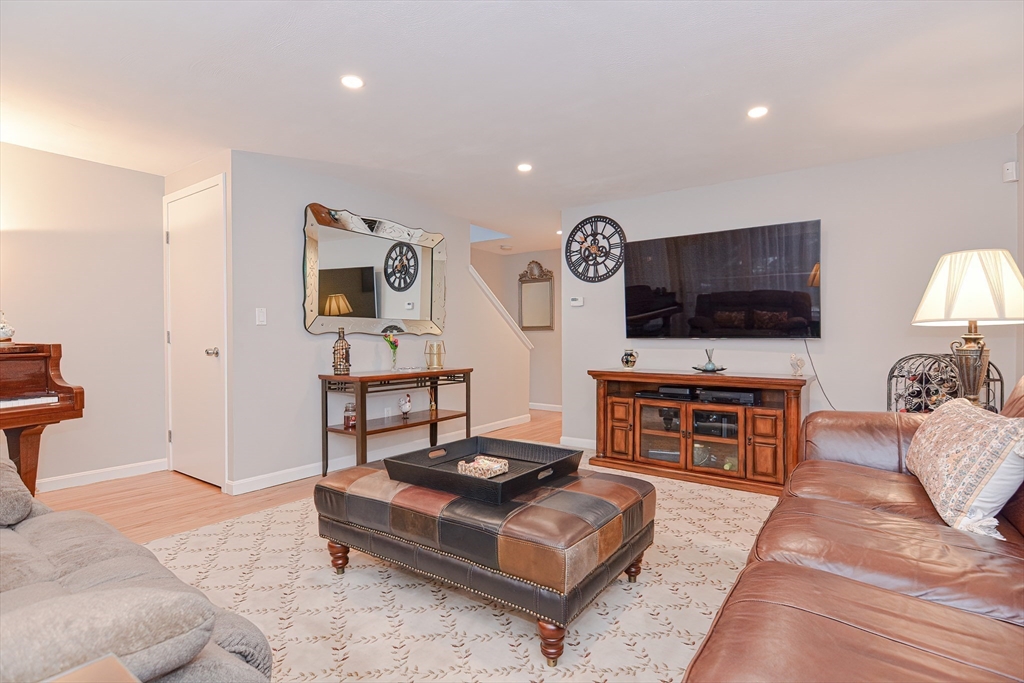 61 Mill Pond, Unit 61 North Andover, MA 01845 - Photo 14 of 31 a living room with furniture and a flat screen tv