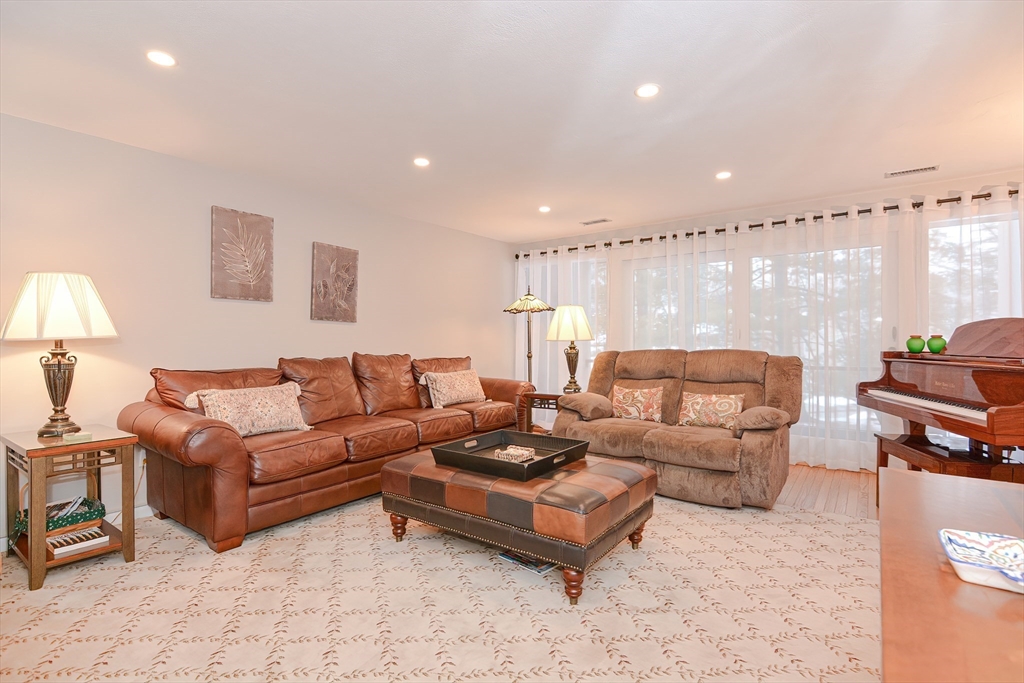 61 Mill Pond, Unit 61 North Andover, MA 01845 - Photo 16 of 31 a living room with furniture and a lamp