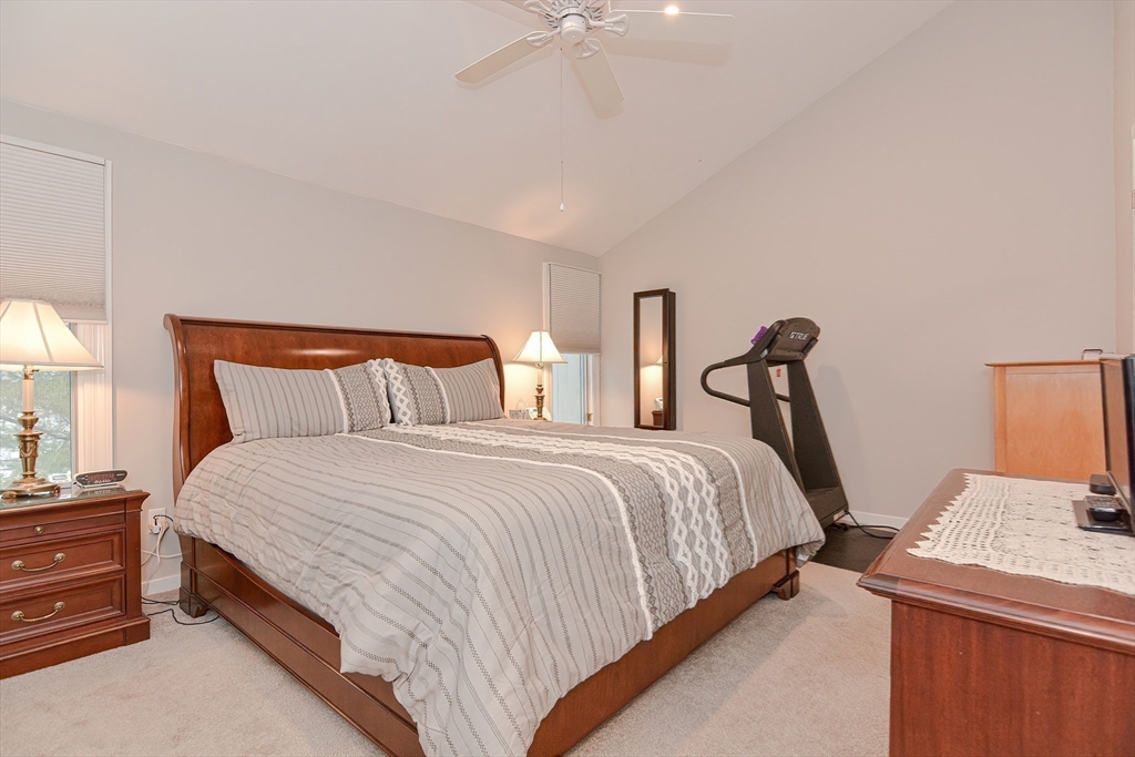 61 Mill Pond, Unit 61 North Andover, MA 01845 - Photo 17 of 31 a bedroom with bed and a chandelier