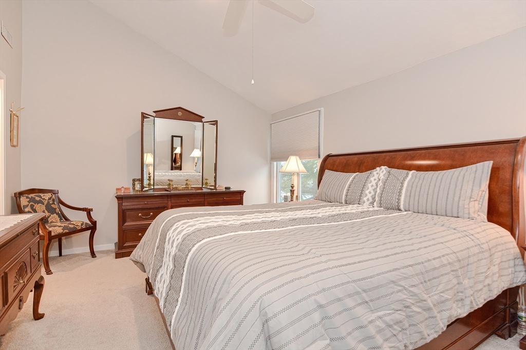 61 Mill Pond, Unit 61 North Andover, MA 01845 - Photo 18 of 31 a bedroom with a bed and a chair