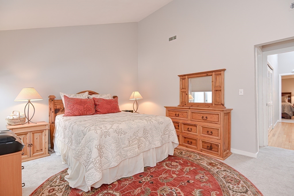61 Mill Pond, Unit 61 North Andover, MA 01845 - Photo 20 of 31 a bedroom with a bed and wooden floor