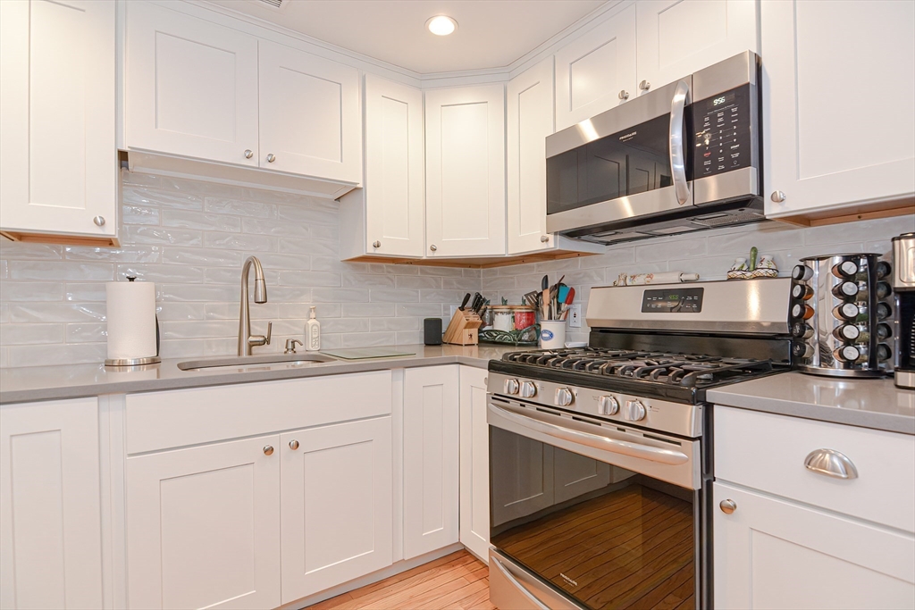 61 Mill Pond, Unit 61 North Andover, MA 01845 - Photo 2 of 31 a kitchen with stainless steel appliances granite countertop a sink a stove top oven and white cabinets