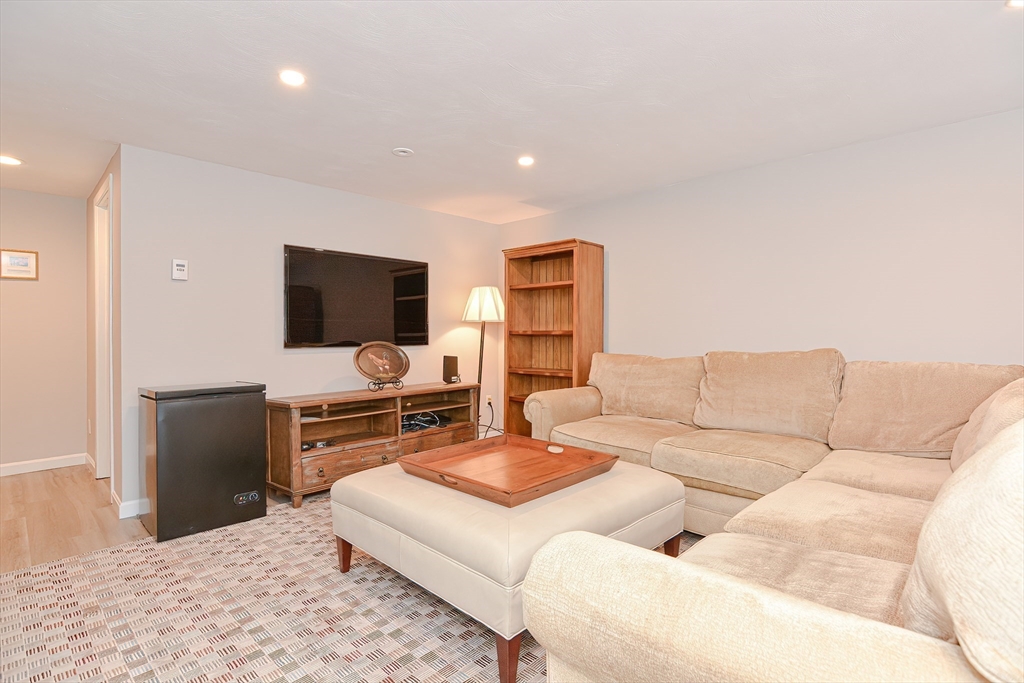 61 Mill Pond, Unit 61 North Andover, MA 01845 - Photo 22 of 31 a living room with furniture and a flat screen tv