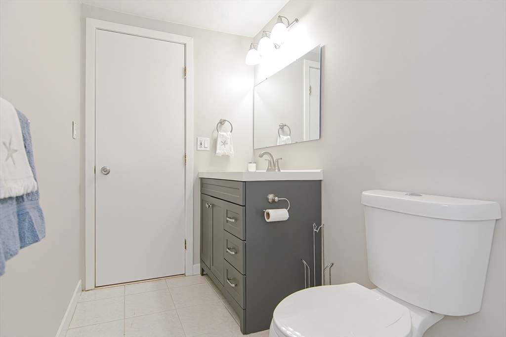 61 Mill Pond, Unit 61 North Andover, MA 01845 - Photo 25 of 31 a bathroom with a toilet a sink and mirror
