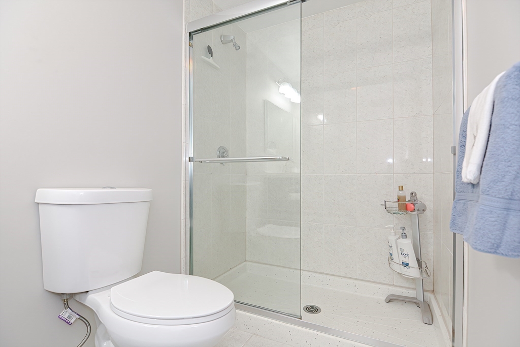 61 Mill Pond, Unit 61 North Andover, MA 01845 - Photo 26 of 31 a bathroom with a shower a toilet and sink