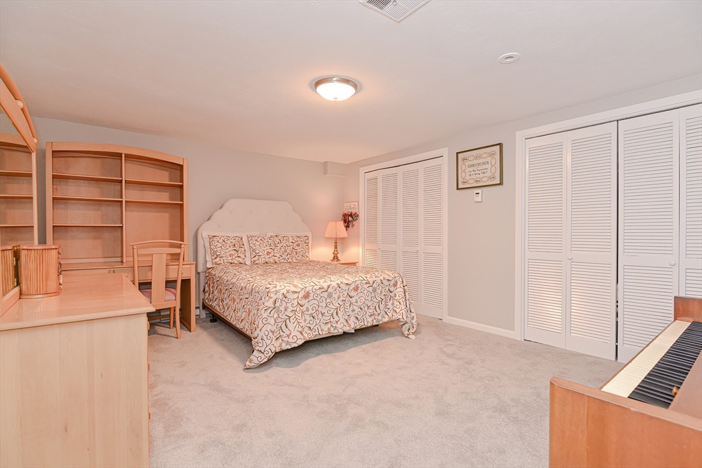 61 Mill Pond, Unit 61 North Andover, MA 01845 - Photo 27 of 31 a bedroom with a bed and a cabinets