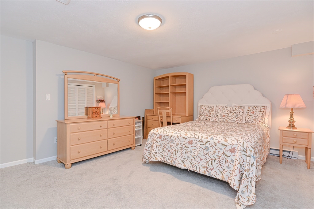 61 Mill Pond, Unit 61 North Andover, MA 01845 - Photo 28 of 31 a bedroom with a bed and a dresser