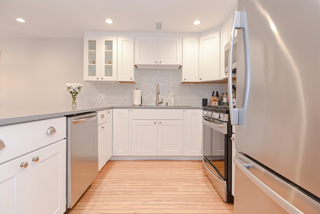 61 Mill Pond, Unit 61 North Andover, MA 01845 - Photo 3 of 31 a kitchen with white cabinets and appliances