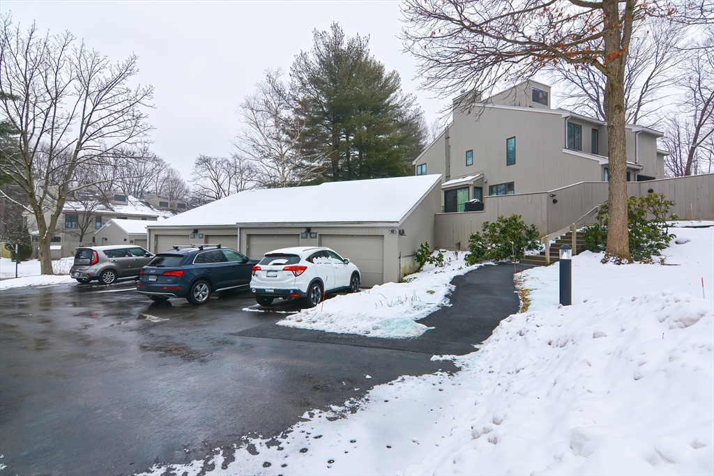61 Mill Pond, Unit 61 North Andover, MA 01845 - Photo 31 of 31 a view of a white house covered with snow on the road