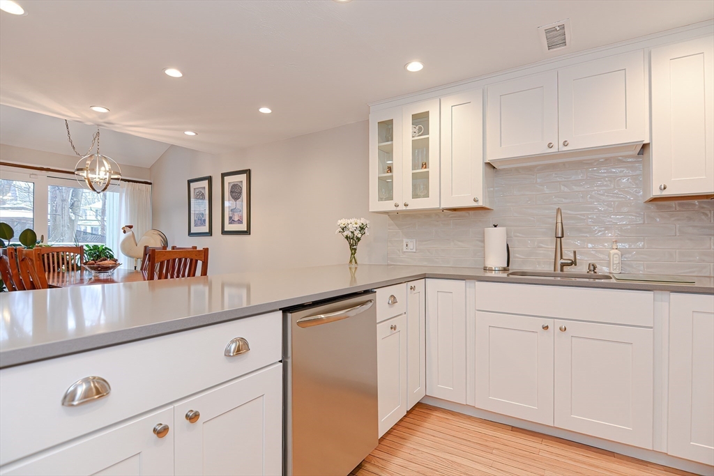 61 Mill Pond, Unit 61 North Andover, MA 01845 - Photo 5 of 31 a kitchen with granite countertop white cabinets and white appliances