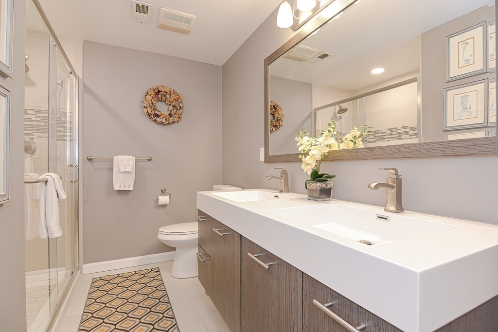 61 Mill Pond, Unit 61 North Andover, MA 01845 - Photo 9 of 31 a bathroom with a sink a toilet and a mirror