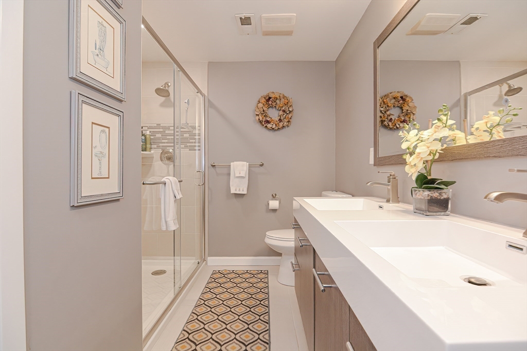 61 Mill Pond, Unit 61 North Andover, MA 01845 - Photo 10 of 31 a bathroom with a sink a vanity and a mirror