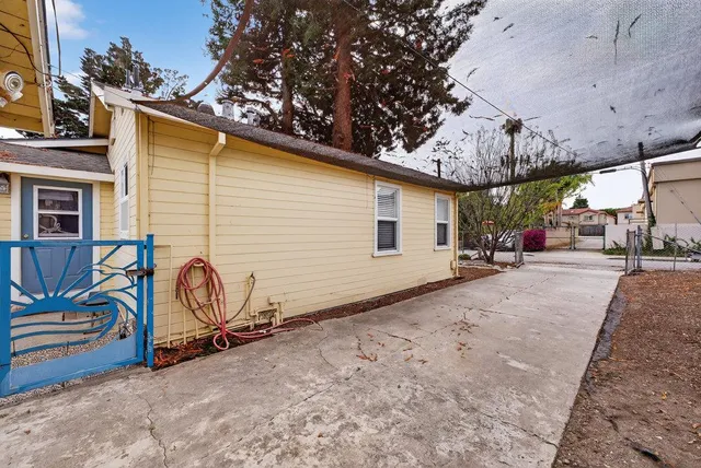 a view of a house with backyard and sitting area