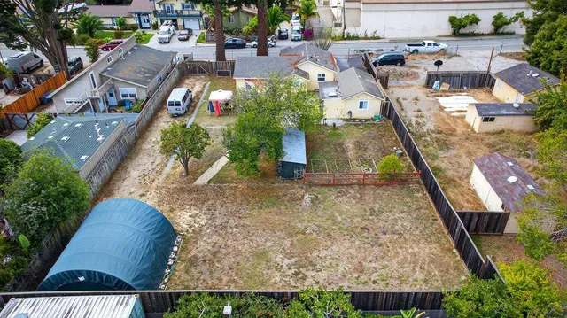 an aerial view of multiple houses with yard
