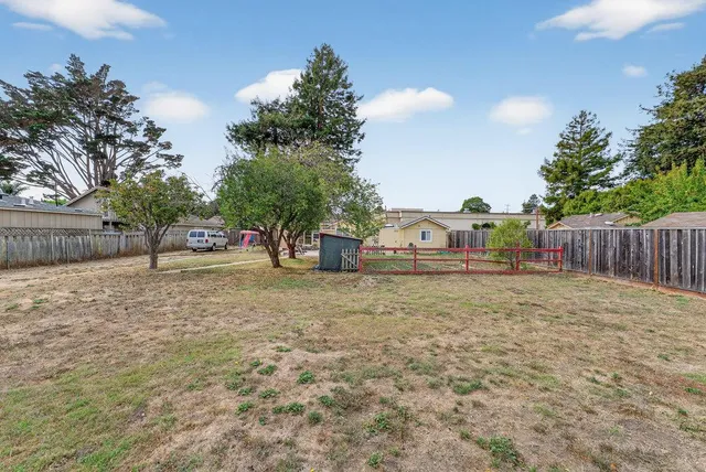 an aerial view of a house with a yard and a fountain