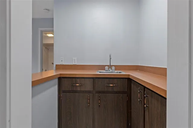 a view of room with a ceiling fan and windows