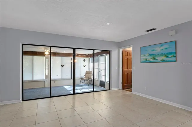 a view of an empty room with glass door