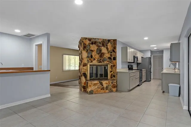 a view of a kitchen with fridge and workspace