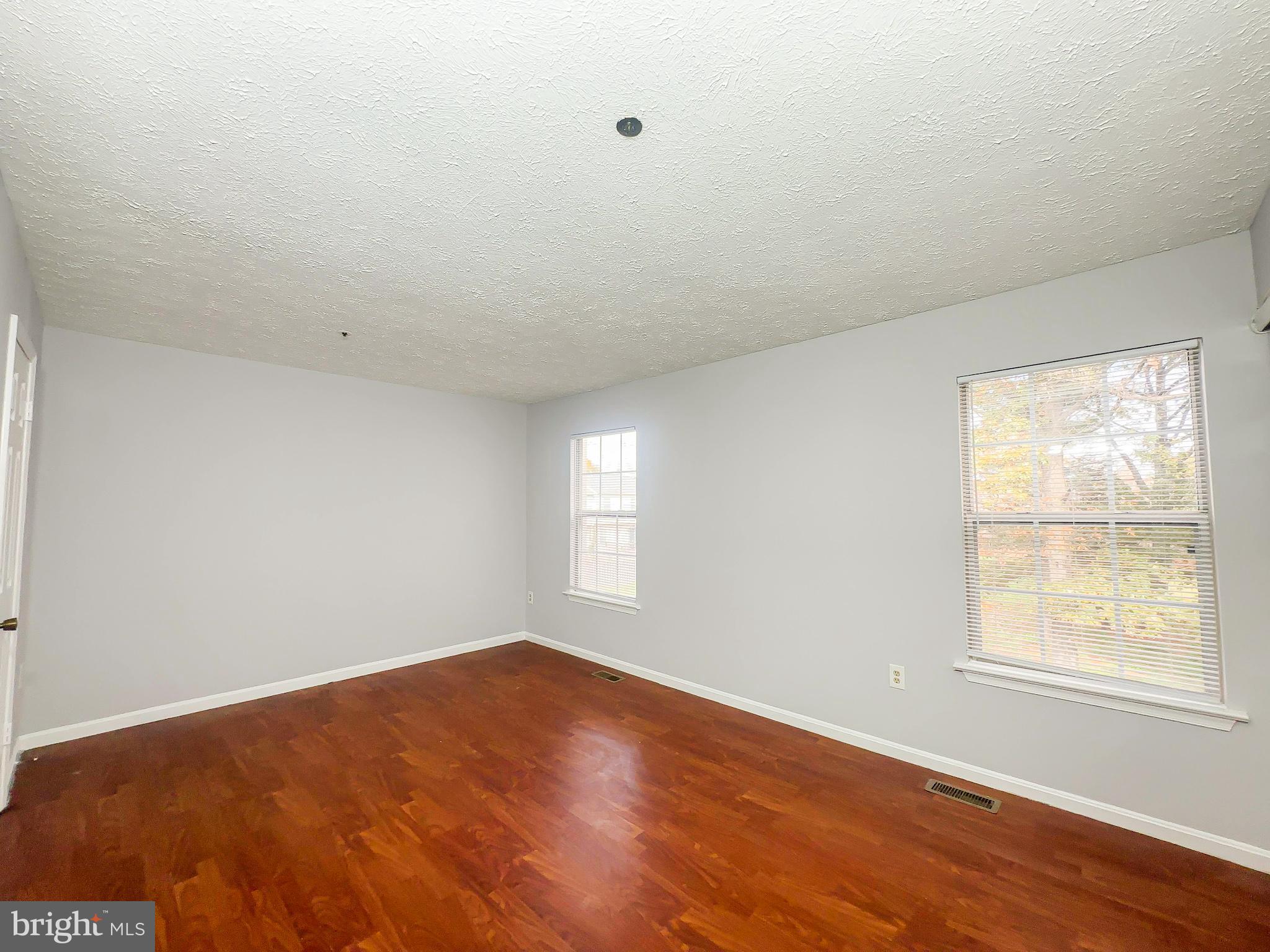 3714 Silver Park Court Suitland, MD 20746 - Photo 11 of 26 an empty room with wooden floor and windows