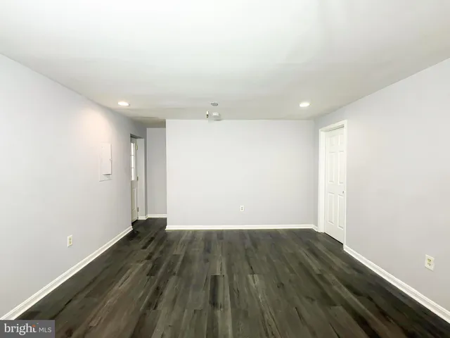an empty room with wooden floor