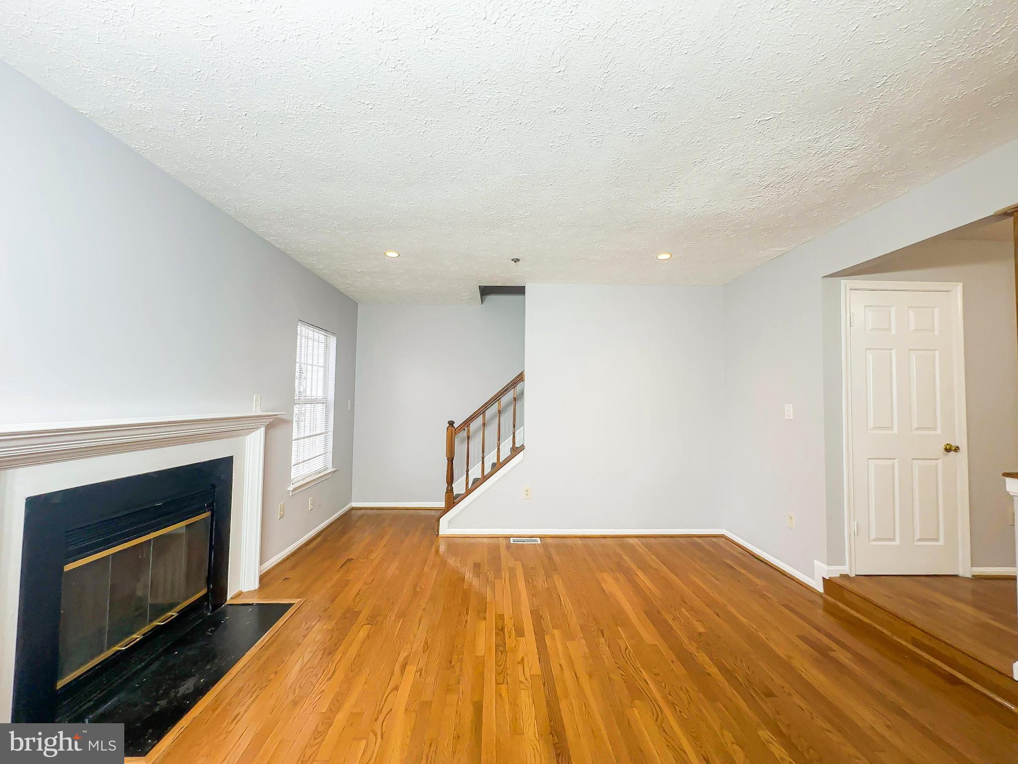 3714 Silver Park Court Suitland, MD 20746 - Photo 4 of 26 a view of empty room with wooden floor and fireplace