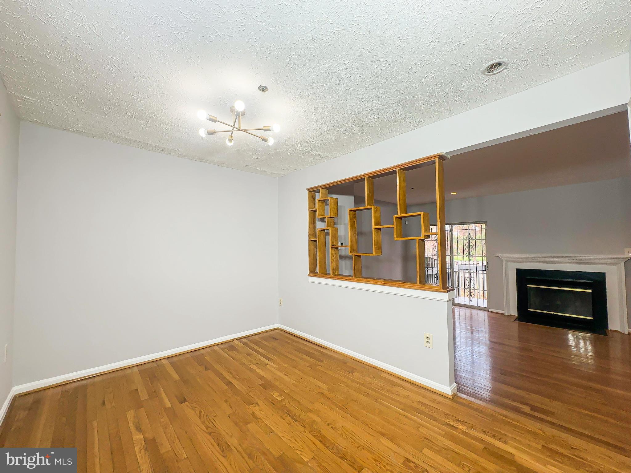 3714 Silver Park Court Suitland, MD 20746 - Photo 6 of 26 a view of an empty room with window and wooden floor