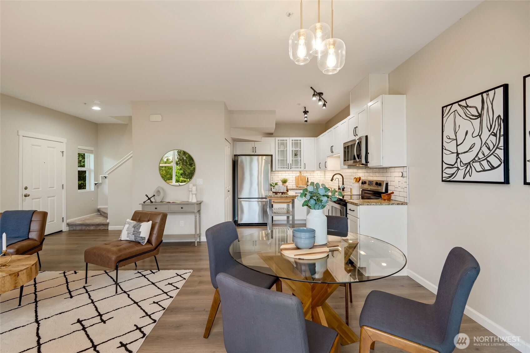 2800 Southwest Raymond Street, Unit 207 Seattle, WA 98126 - Photo 12 of 38 a view of a dining room with furniture a rug and wooden floor